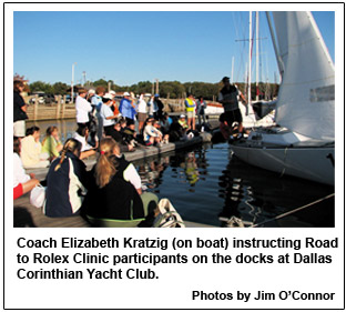 Coach Elizabeth Kratzig (on boat) instructing Road to Rolex Clinic participants on the docks at Dallas Corinthian Yacht Club