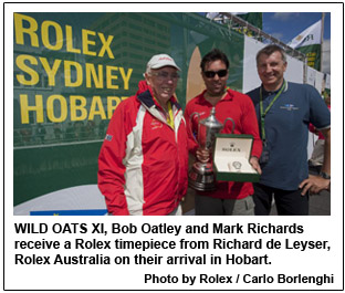 WILD OATS XI, Bob Oatley and Mark Richards receive a Rolex timepiece from Richard de Leyser, Rolex Australia on their arrival in Hobart.