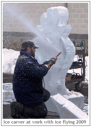 Ice carver at work with ice flying 2009