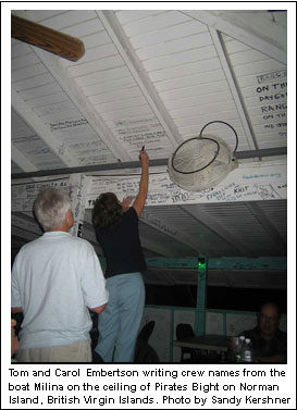 Tom and Carol Embertson writing crew names from the boat Milina on the ceiling of Pirates Bight on Norman Island, British Virgin Islands. Photo by Sandy Kershner