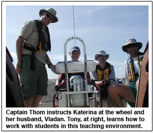 Captain Thom instructs Katerina at the wheel and her husband, Vladan. Tony, at right, learns how to work with students in this teaching environment.
