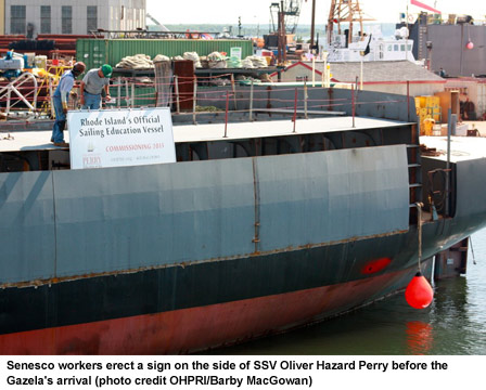 Senesco workers erect a sign on the side of SSV Oliver Hazard Perry before the Gazela's arrival (photo credit OHPRI/Barby MacGowan)