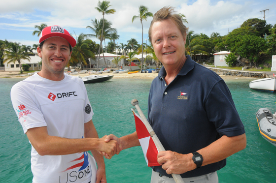 R to L: Taylor Canfield, Virgin Islands Sailor of the Year for 2013, Phillip Shannon, President of the Virgin Islands Sailing Association, with the iconic St. Thomas Yacht Club in the background. (Credit: Dean Barnes)