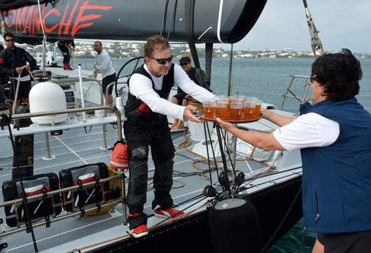 Dark 'n Stormies all round! Leatrice Oatley, Commodore of the Royal Bermuda YC hands Ken Read, skipper of COMANCHE crew rations to celebrate their record run. Photo: Barry Pickthall/PPL