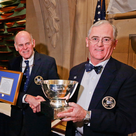 The Cruising Club of America Commodore Frederic T. Lhamon (left) presents the 2013 Richard S. Nye Trophy to Stephen E. Taylor (right) for sharing with the club his meritorious service and extensive cruising experience (Photo Credit CCA/Dan Nerney).