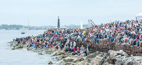 Thousands of fans line the rocks in Newport Harbour to watch the Volvo Ocean Race In-Port Race