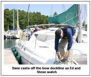 Dave casts off the bow dockline as Ed and Steve watch