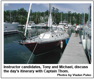 Instructor candidates, Tony and Michael, discuss the day�s itinerary with Captain Thom