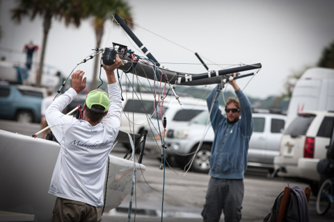 Olympic Laser sailor Mark Mendelblatt, right, hoists the mast of a Melges 20 before that class' National Championship at Sperry Charleston Race Week.