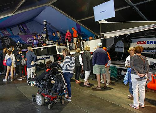 Visitors climb onboard the full-sized half hull