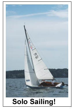 Ensign solo sailing upwind.