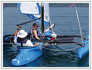 WindRider 17 is friendly to sailing dog Dewey as well as Thom and Michele.