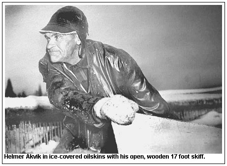 Helmer Akvik in ice-covered oilskins with his open, wooden 17 foot skiff.