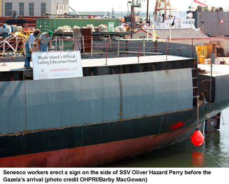 Senesco workers erect a sign on the side of SSV Oliver Hazard Perry before the Gazela's arrival (photo credit OHPRI/Barby MacGowan)