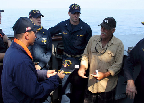Cmdr. John Barsano, commanding officer of the guided-missile destroyer USS Paul Hamilton (DDG 60), welcomes Ron Ingraham aboard the Arleigh Burke-class guided-missile destroyer USS Paul Hamilton (DDG 60). Ingraham was stranded at sea without food or water since Nov. 27. A U.S. Coast Guard cutter later responded to tow the vessel back to port.