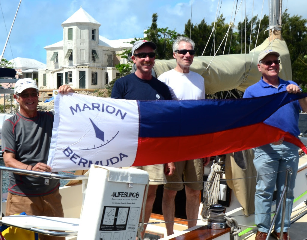 Dave Patton (L) Marion Bermuda Cruising Yacht Race Association Chairman, and Wilie Forbes Vice Commodore of the Royal Hamilton Amateur Dinghy Club (Far Right) present the Winner's Banner to Chip Brandish (center left) skipper of 'Selkie' and Watch Captain George Dyroff.<br>
'Selkie', Chip Bradish's 1988 Morris Ocean 32.5 footer from Boston was the overall corrected time winner of Class D and the entire 40th Anniversary Marion Bermuda Race. Photo by Talbot Wilson